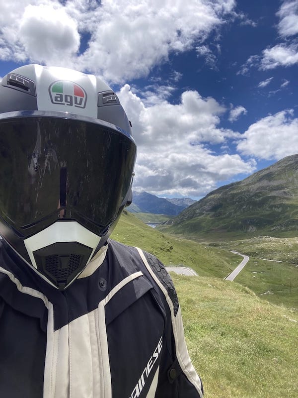Helmet selfie above an alpine pass road in Switzerland