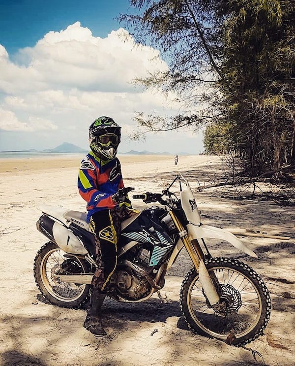 Riding a dirt bike on a beach in Thailand